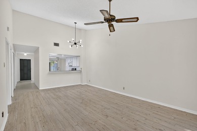 Enjoy stunning lake and golf course views right from your living on Heritage Ridge Golf Club in Florida - for sale on GolfHomes.com, golf home, golf lot