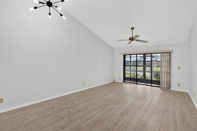 Enjoy stunning lake and golf course views right from your living on Heritage Ridge Golf Club in Florida - for sale on GolfHomes.com, golf home, golf lot