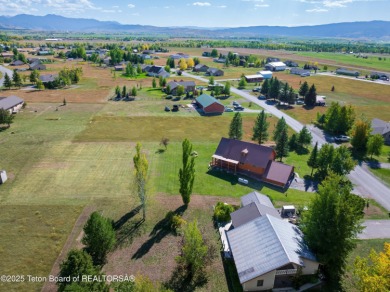 This beautiful log home combines rustic charm with modern on Star Valley RV Golf Course in Wyoming - for sale on GolfHomes.com, golf home, golf lot