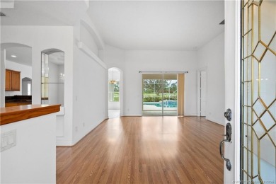 Step inside and fall in love with the view - a sparkling pool on Eagle Marsh Golf Club in Florida - for sale on GolfHomes.com, golf home, golf lot