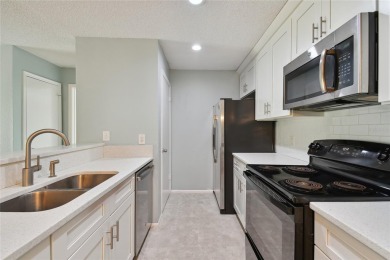 Spacious END UNIT with 3 bedrooms and 2 full bathrooms WITH A on Hunters Green Country Club in Florida - for sale on GolfHomes.com, golf home, golf lot