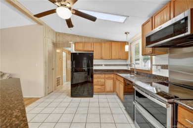 LAND OWNED-NO LAND LEASE! Welcome to 2629 Caper Court in the on Spanish Lakes Golf Village in Florida - for sale on GolfHomes.com, golf home, golf lot