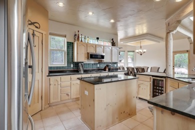 This custom Leo Husky home is a beautiful combination of nature on Paa-Ko Ridge Golf Club  in New Mexico - for sale on GolfHomes.com, golf home, golf lot