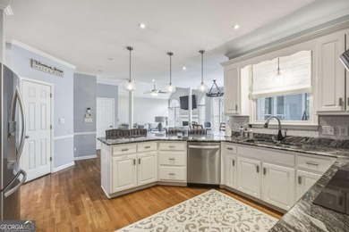 Welcome to this 5-bedroom home that sits on a corner lot and on Towne Lake Hills Golf Club in Georgia - for sale on GolfHomes.com, golf home, golf lot