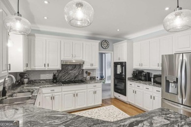 Welcome to this 5-bedroom home that sits on a corner lot and on Towne Lake Hills Golf Club in Georgia - for sale on GolfHomes.com, golf home, golf lot