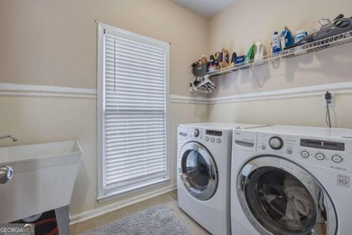 Welcome to this 5-bedroom home that sits on a corner lot and on Towne Lake Hills Golf Club in Georgia - for sale on GolfHomes.com, golf home, golf lot