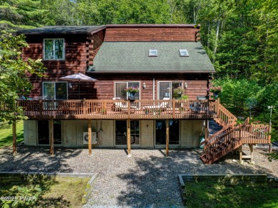 Meticulously maintained log-sided lakefront on TinkWig Lake with on Woodloch Springs Country Club in Pennsylvania - for sale on GolfHomes.com, golf home, golf lot