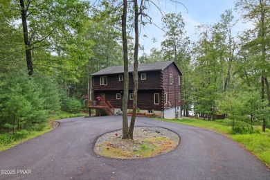 Meticulously maintained log-sided lakefront on TinkWig Lake with on Woodloch Springs Country Club in Pennsylvania - for sale on GolfHomes.com, golf home, golf lot