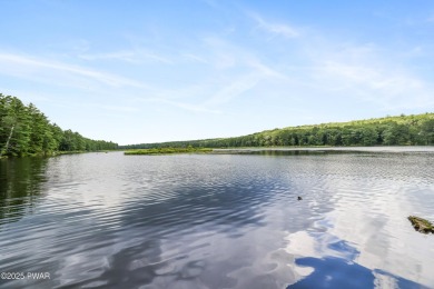 Meticulously maintained log-sided lakefront on TinkWig Lake with on Woodloch Springs Country Club in Pennsylvania - for sale on GolfHomes.com, golf home, golf lot