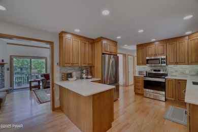 Meticulously maintained log-sided lakefront on TinkWig Lake with on Woodloch Springs Country Club in Pennsylvania - for sale on GolfHomes.com, golf home, golf lot