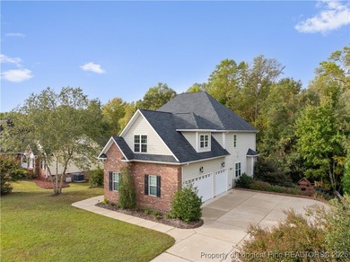 Nestled in a peaceful setting in Gates Four, this beautiful home on Gates Four Golf and Country Club in North Carolina - for sale on GolfHomes.com, golf home, golf lot