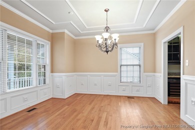 Nestled in a peaceful setting in Gates Four, this beautiful home on Gates Four Golf and Country Club in North Carolina - for sale on GolfHomes.com, golf home, golf lot