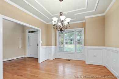 Nestled in a peaceful setting in Gates Four, this beautiful home on Gates Four Golf and Country Club in North Carolina - for sale on GolfHomes.com, golf home, golf lot