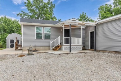 Welcome to your meticulously crafted retreat in the serene on Linn Valley Lakes - Deer Trace Golf Course in Kansas - for sale on GolfHomes.com, golf home, golf lot