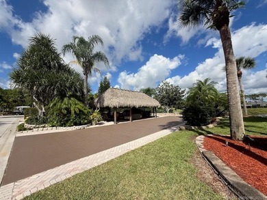 Exceptional Lot with Banyan Tree and Lake Views - Move-In Ready! on St. Lucie Trail Golf Club in Florida - for sale on GolfHomes.com, golf home, golf lot