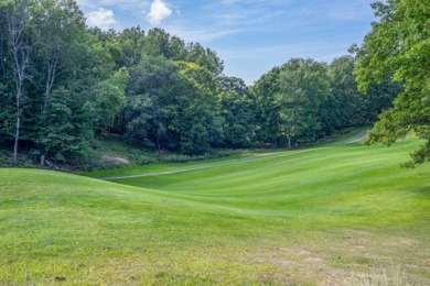 Discover the epitome of tranquility with this charming on Canadian Lakes Country Club-The Highlands Course in Michigan - for sale on GolfHomes.com, golf home, golf lot