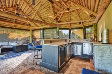 Turnkey RV Lot with Premium Tiki and Lake Views! Enjoy on Motorcoach Resort Golf Course in Florida - for sale on GolfHomes.com, golf home, golf lot