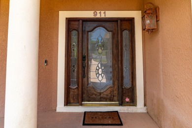 This immaculately maintained, custom-built home overlooks the on Shalimar Pointe Golf and Country Club in Florida - for sale on GolfHomes.com, golf home, golf lot