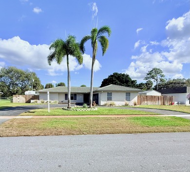 Golf-course living without the HOA! This 3-bedroom, 2-bath home on Palm Beach National Golf and Country Club in Florida - for sale on GolfHomes.com, golf home, golf lot
