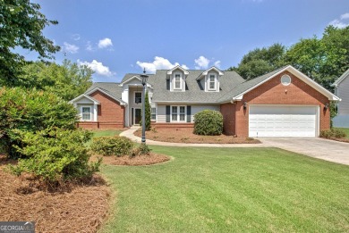This bright, sunlit gem is situated overlooking a beautiful lake on Braelinn Golf Club in Georgia - for sale on GolfHomes.com, golf home, golf lot