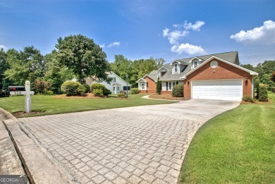 This bright, sunlit gem is situated overlooking a beautiful lake on Braelinn Golf Club in Georgia - for sale on GolfHomes.com, golf home, golf lot