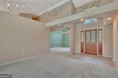 This bright, sunlit gem is situated overlooking a beautiful lake on Braelinn Golf Club in Georgia - for sale on GolfHomes.com, golf home, golf lot