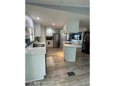 This property boasts numerous desirable features. New Roof 2023 on Barefoot Bay Golf Course in Florida - for sale on GolfHomes.com, golf home, golf lot