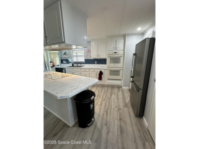 This property boasts numerous desirable features. New Roof 2023 on Barefoot Bay Golf Course in Florida - for sale on GolfHomes.com, golf home, golf lot