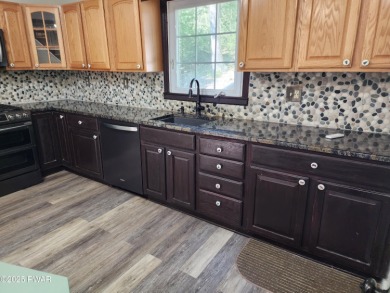 Entertainers delight inside and out with surprise lake view and on Lords Valley Country Club, Inc in Pennsylvania - for sale on GolfHomes.com, golf home, golf lot