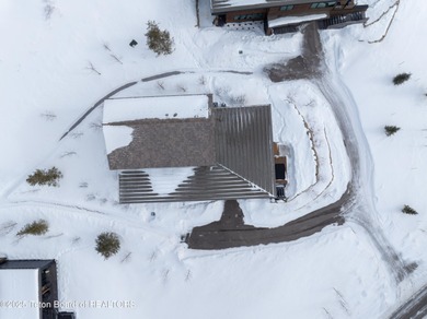 Indulge in the ultimate mountain retreat with this fully on Snake River Sporting Club in Wyoming - for sale on GolfHomes.com, golf home, golf lot