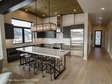 Indulge in the ultimate mountain retreat with this fully on Snake River Sporting Club in Wyoming - for sale on GolfHomes.com, golf home, golf lot