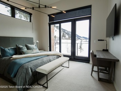 Indulge in the ultimate mountain retreat with this fully on Snake River Sporting Club in Wyoming - for sale on GolfHomes.com, golf home, golf lot