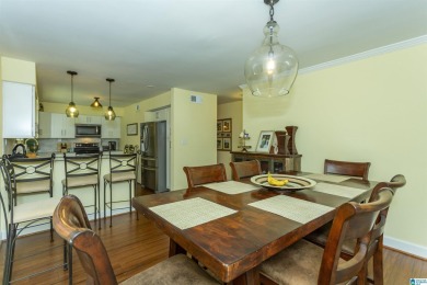 This home sits nestled in a wooded setting and water vista view on Inverness Country Club in Alabama - for sale on GolfHomes.com, golf home, golf lot