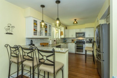 This home sits nestled in a wooded setting and water vista view on Inverness Country Club in Alabama - for sale on GolfHomes.com, golf home, golf lot