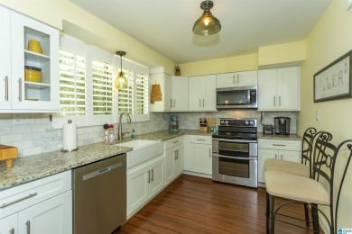 This home sits nestled in a wooded setting and water vista view on Inverness Country Club in Alabama - for sale on GolfHomes.com, golf home, golf lot