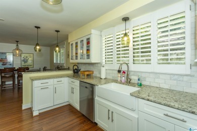 This home sits nestled in a wooded setting and water vista view on Inverness Country Club in Alabama - for sale on GolfHomes.com, golf home, golf lot