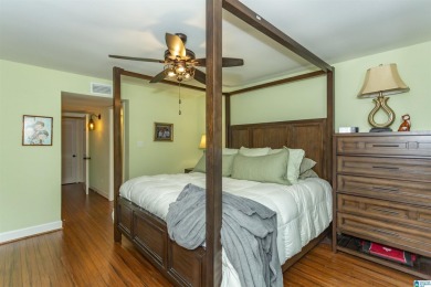 This home sits nestled in a wooded setting and water vista view on Inverness Country Club in Alabama - for sale on GolfHomes.com, golf home, golf lot