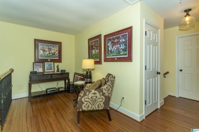 This home sits nestled in a wooded setting and water vista view on Inverness Country Club in Alabama - for sale on GolfHomes.com, golf home, golf lot