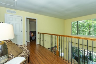 This home sits nestled in a wooded setting and water vista view on Inverness Country Club in Alabama - for sale on GolfHomes.com, golf home, golf lot