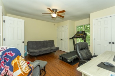 This home sits nestled in a wooded setting and water vista view on Inverness Country Club in Alabama - for sale on GolfHomes.com, golf home, golf lot