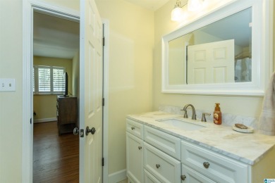 This home sits nestled in a wooded setting and water vista view on Inverness Country Club in Alabama - for sale on GolfHomes.com, golf home, golf lot