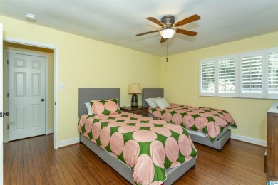 This home sits nestled in a wooded setting and water vista view on Inverness Country Club in Alabama - for sale on GolfHomes.com, golf home, golf lot