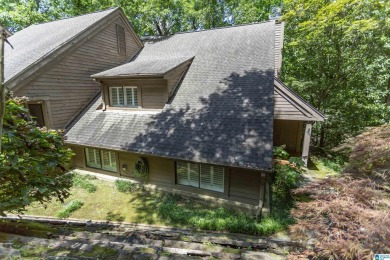 This home sits nestled in a wooded setting and water vista view on Inverness Country Club in Alabama - for sale on GolfHomes.com, golf home, golf lot