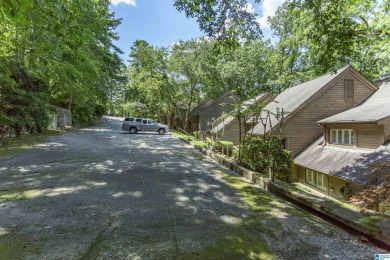 This home sits nestled in a wooded setting and water vista view on Inverness Country Club in Alabama - for sale on GolfHomes.com, golf home, golf lot