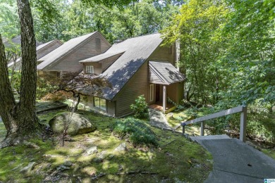 This home sits nestled in a wooded setting and water vista view on Inverness Country Club in Alabama - for sale on GolfHomes.com, golf home, golf lot
