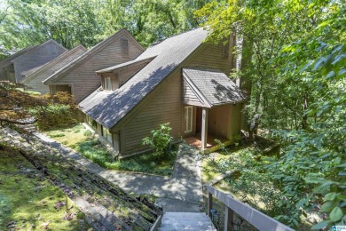 This home sits nestled in a wooded setting and water vista view on Inverness Country Club in Alabama - for sale on GolfHomes.com, golf home, golf lot