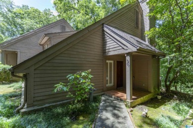 This home sits nestled in a wooded setting and water vista view on Inverness Country Club in Alabama - for sale on GolfHomes.com, golf home, golf lot