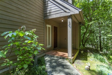 This home sits nestled in a wooded setting and water vista view on Inverness Country Club in Alabama - for sale on GolfHomes.com, golf home, golf lot