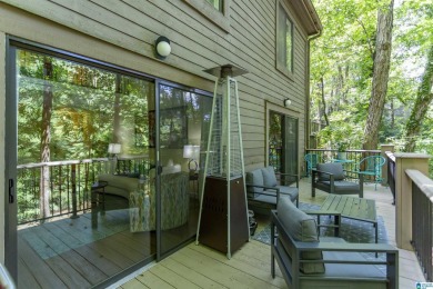 This home sits nestled in a wooded setting and water vista view on Inverness Country Club in Alabama - for sale on GolfHomes.com, golf home, golf lot