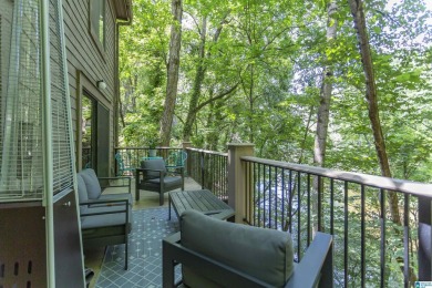 This home sits nestled in a wooded setting and water vista view on Inverness Country Club in Alabama - for sale on GolfHomes.com, golf home, golf lot